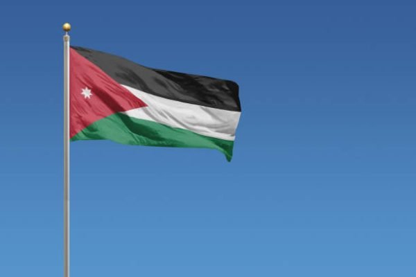 Flag of Jordan in front of a clear blue sky